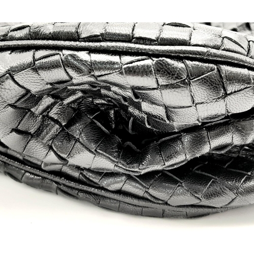 138 - A Bottega Veneta Black Bag. Intrecciato leather exterior with two rolled leather handles. Beige text... 