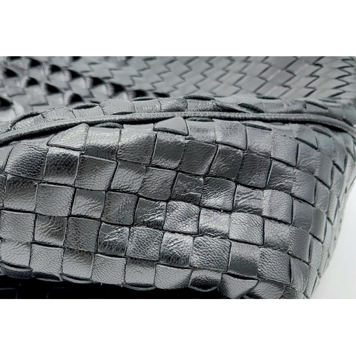 138 - A Bottega Veneta Black Bag. Intrecciato leather exterior with two rolled leather handles. Beige text... 