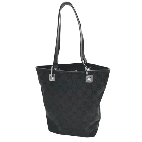 5 - A Gucci Black Monogram Tote Bag. Canvas exterior with leather trim, two leather straps and silver-to... 