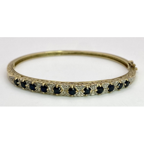 38 - A 9K YELLOW GOLD DIAMOND & SAPPHIRE SET BANGLE 10.4G , 55mm x 63mm diameter.

SC 9005