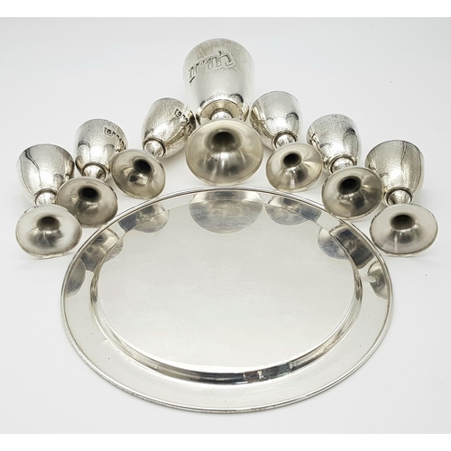 84 - An Israeli 925 Silver Kiddush Cup Set with Serving Plate. One large cup and six smaller cups. 425g t... 