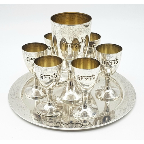 84 - An Israeli 925 Silver Kiddush Cup Set with Serving Plate. One large cup and six smaller cups. 425g t... 