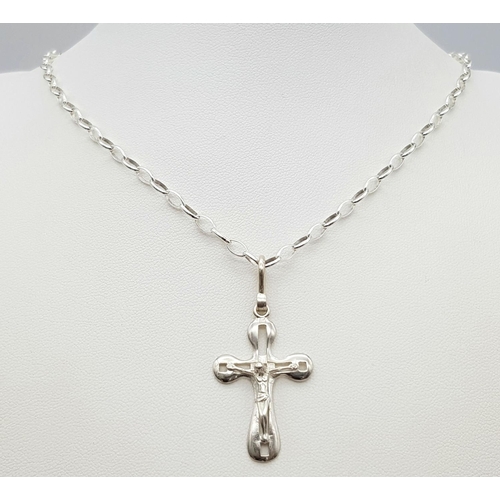 985 - A Sterling Silver Crucifix on a Silver Chain. 3cm and 40cm.