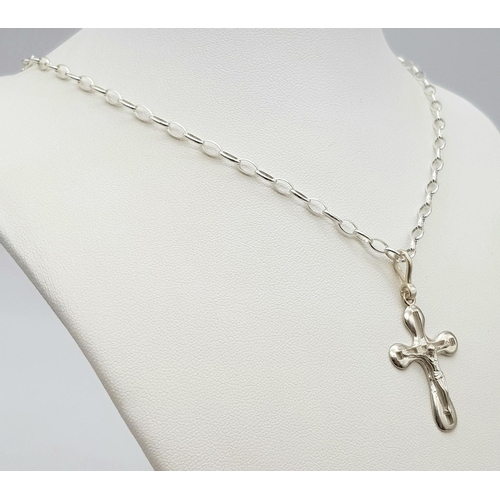 985 - A Sterling Silver Crucifix on a Silver Chain. 3cm and 40cm.