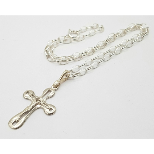 985 - A Sterling Silver Crucifix on a Silver Chain. 3cm and 40cm.