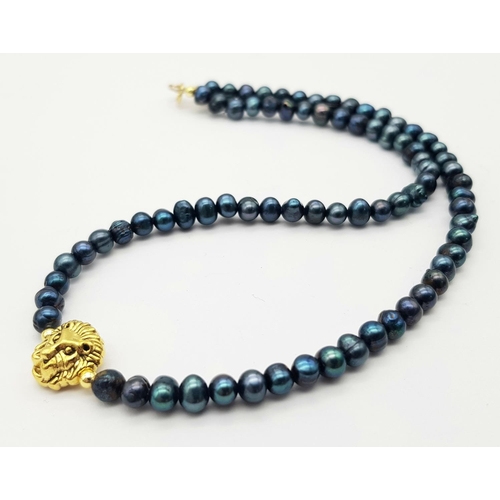 991 - A Gilded Metal Lion Figure on a Blue Small Beaded Necklace. 14k gold clasp. 36cm.