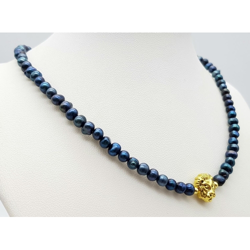 991 - A Gilded Metal Lion Figure on a Blue Small Beaded Necklace. 14k gold clasp. 36cm.