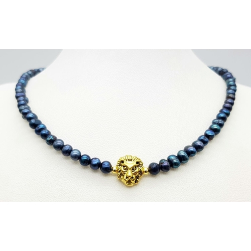 991 - A Gilded Metal Lion Figure on a Blue Small Beaded Necklace. 14k gold clasp. 36cm.