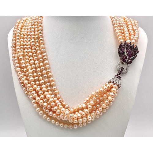 133 - A very glamorous, eleven strand (yes eleven!!!) genuine natural pink pearl necklace with a large, st... 