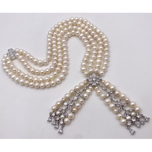 196 - A fabulously designed pearl necklace with cubic zirconia. The genuine natural white pearls are of ex... 