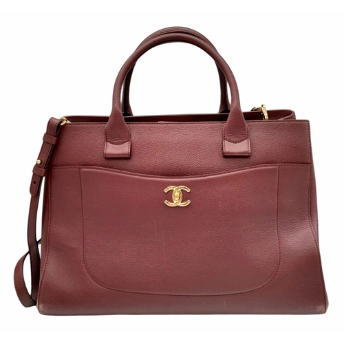 99 - A Chanel Neo Executive Leather Tote Bag. Burgundy leather exterior with gold tone hardware and two l... 