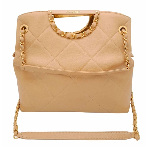 122 - A Chanel Two-Way Chain Shoulder Bag. Beige caviar leather.
Gold tone hardware. Spacious interior wit... 