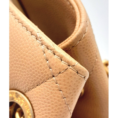122 - A Chanel Two-Way Chain Shoulder Bag. Beige caviar leather.
Gold tone hardware. Spacious interior wit... 