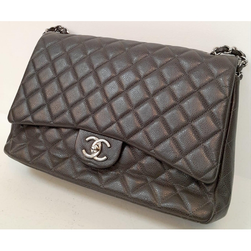 129 - A Chanel Jumbo Double Flap Maxi Bag. Dark grey quilted caviar leather exterior with a large slip poc... 