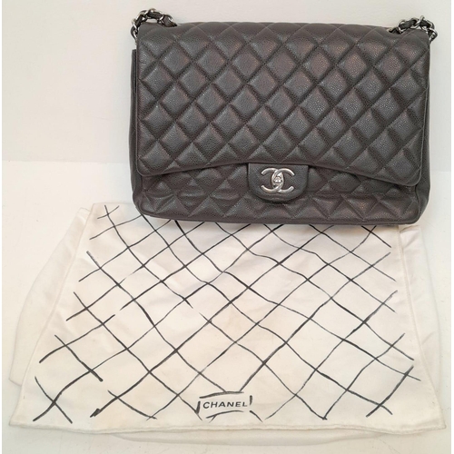 129 - A Chanel Jumbo Double Flap Maxi Bag. Dark grey quilted caviar leather exterior with a large slip poc... 