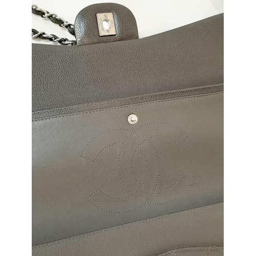 129 - A Chanel Jumbo Double Flap Maxi Bag. Dark grey quilted caviar leather exterior with a large slip poc... 