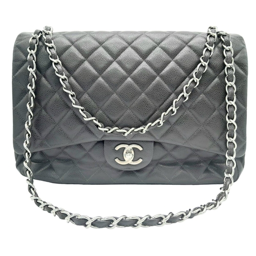129 - A Chanel Jumbo Double Flap Maxi Bag. Dark grey quilted caviar leather exterior with a large slip poc... 