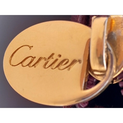 170 - A Vintage Cartier Burgundy Pouch. Leather exterior with zip top closure. Burgundy canvas interior. A... 