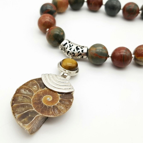 147 - An unusual jasper necklace with a Jurassic Ammonite from Madagascar, a bracelet, and a pair of match... 