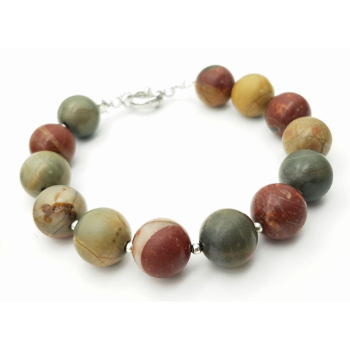 147 - An unusual jasper necklace with a Jurassic Ammonite from Madagascar, a bracelet, and a pair of match... 