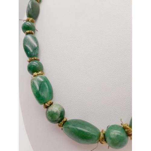 164 - A Wonderful Antique Chinese Green Jade Necklace. 52cm. No clasp - overhead fit. Various bead sizes.