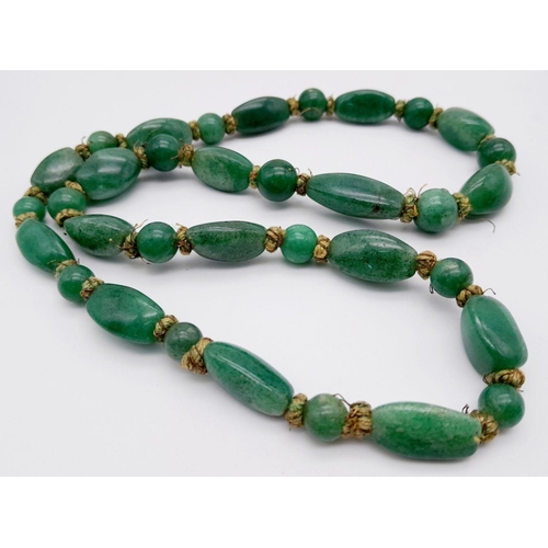 164 - A Wonderful Antique Chinese Green Jade Necklace. 52cm. No clasp - overhead fit. Various bead sizes.