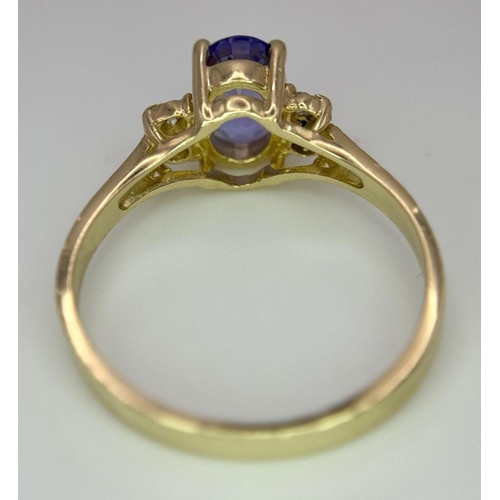 214 - A 14K YELLOW GOLD DIAMOND & TANZANITE RING - 1.9G. SIZE L