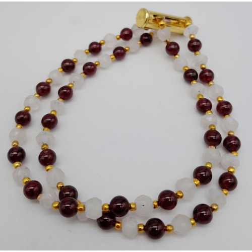 238 - An elegant and sophisticated two strand moonstone and garnet necklace and matching bracelet set. Nec... 