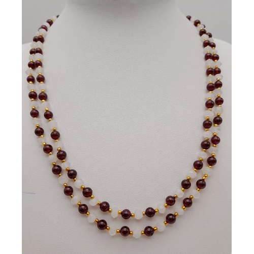 238 - An elegant and sophisticated two strand moonstone and garnet necklace and matching bracelet set. Nec... 