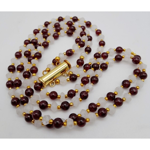 238 - An elegant and sophisticated two strand moonstone and garnet necklace and matching bracelet set. Nec... 