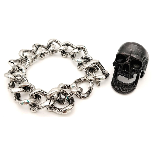 245 - A vintage “biker’s” stash, a stainless-steel scull bracelet and a “Dracula” scull ring with a dark p... 