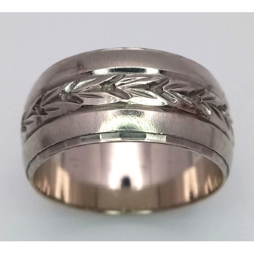 255 - A 14k white gold 9mm wide engraved centre band ring. Size P. 8.3g