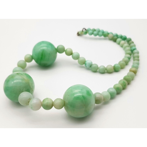 344 - A Vintage Light Green Jade Graduated Bead Necklace. 20mm largest beads. 40cm necklace length.