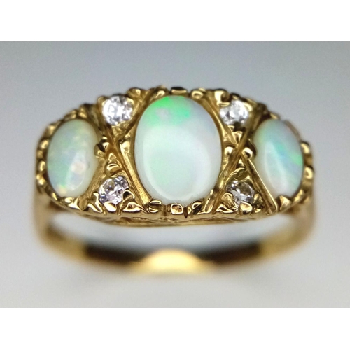 365 - A Vintage 9K Yellow Gold Three Opal and Diamond Ring. Three opal cabochons with excellent colour-pla... 