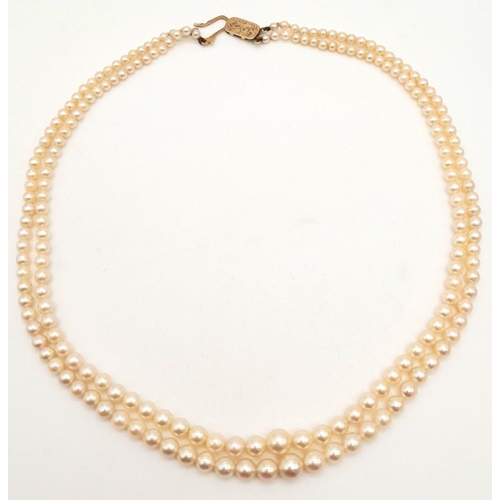 408 - A Vintage Two Row Graduated Pearl Necklace with a 9K Gold Clasp. 42cm