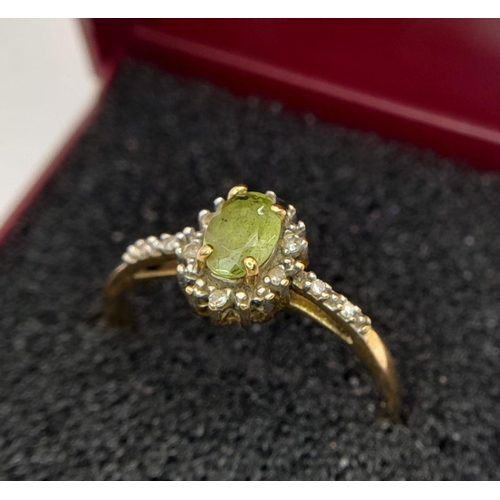 56 - Attractive 9 Carat GOLD PERIDOT and DIAMOND RING, having an Oval Cut Peridot with DIAMOND surround a... 