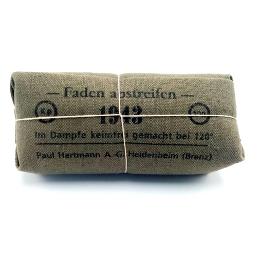 566 - 1943 Dated Waffen SS Field Dressing. From a wooden crate of unissued dressings