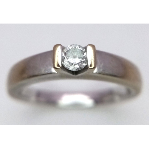 77 - 18 carat WHITE GOLD and DIAMOND SOLITAIRE RING. Having a .15 carat DIAMOND mounted to top in contras... 