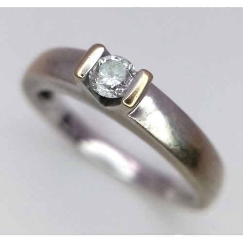 77 - 18 carat WHITE GOLD and DIAMOND SOLITAIRE RING. Having a .15 carat DIAMOND mounted to top in contras... 