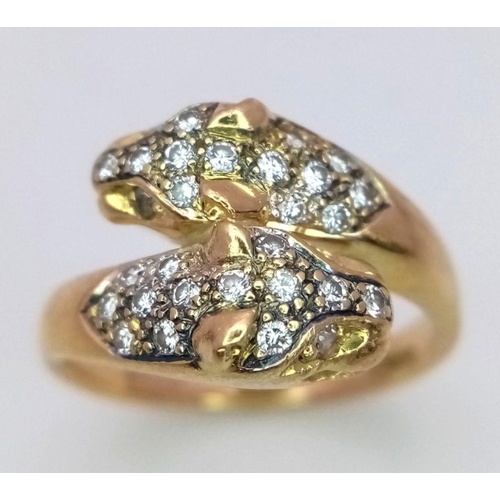 109 - AN 18K YELLOW GOLD DIAMOND SET DOUBLE HEADED PANTHER RING. 0.30CT. 5.7G. SIZE O