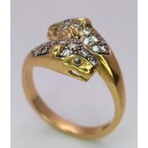 109 - AN 18K YELLOW GOLD DIAMOND SET DOUBLE HEADED PANTHER RING. 0.30CT. 5.7G. SIZE O