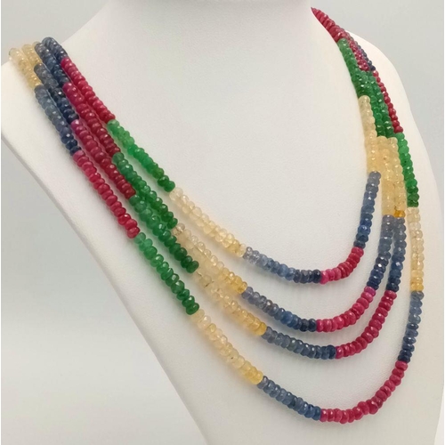 277 - A Four Row Multi-Gemstone Necklace. Emeralds, sapphires and rubies with an 18K gold clasp. 48-52cm. ... 