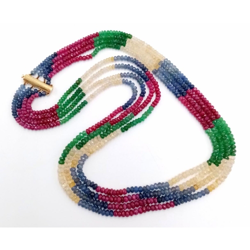 277 - A Four Row Multi-Gemstone Necklace. Emeralds, sapphires and rubies with an 18K gold clasp. 48-52cm. ... 