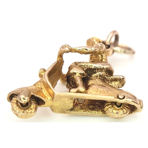 327 - A 9K YELLOW GOLD PERSON ON SCOOTER CHARM WITH MOVING WHEELS! 3.3G