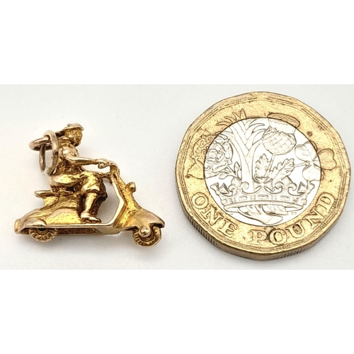 327 - A 9K YELLOW GOLD PERSON ON SCOOTER CHARM WITH MOVING WHEELS! 3.3G