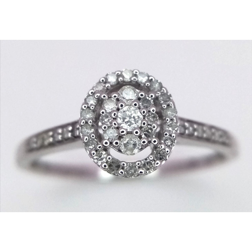 502 - A 9K WHITE GOLD DIAMOND SET HALO RING - 0.22CT. 1.7G. SIZE P