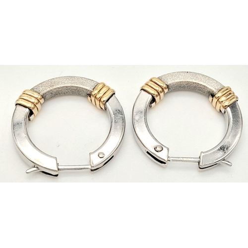 570 - A pair of 9k two-tone hooped earrings. 3.3g total weight.