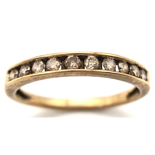 607 - A 9K YELLOW GOLD ( TESTED ) DIAMOND SET BAND RING. 0.20CT. 1.4G. SIZE L