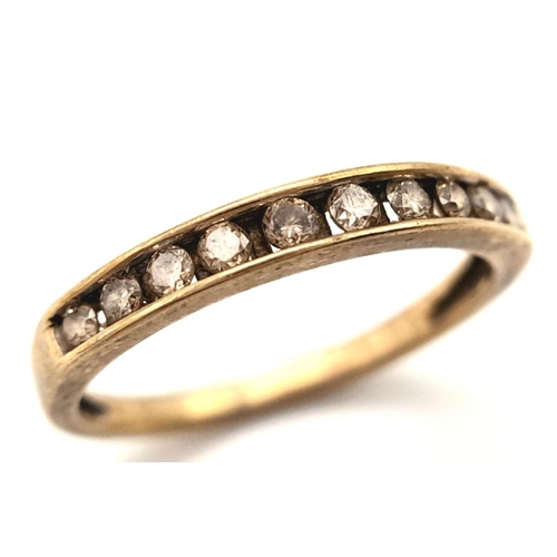 607 - A 9K YELLOW GOLD ( TESTED ) DIAMOND SET BAND RING. 0.20CT. 1.4G. SIZE L