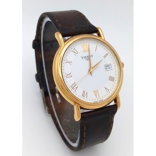 122 - AN 18K GOLD TISSOT